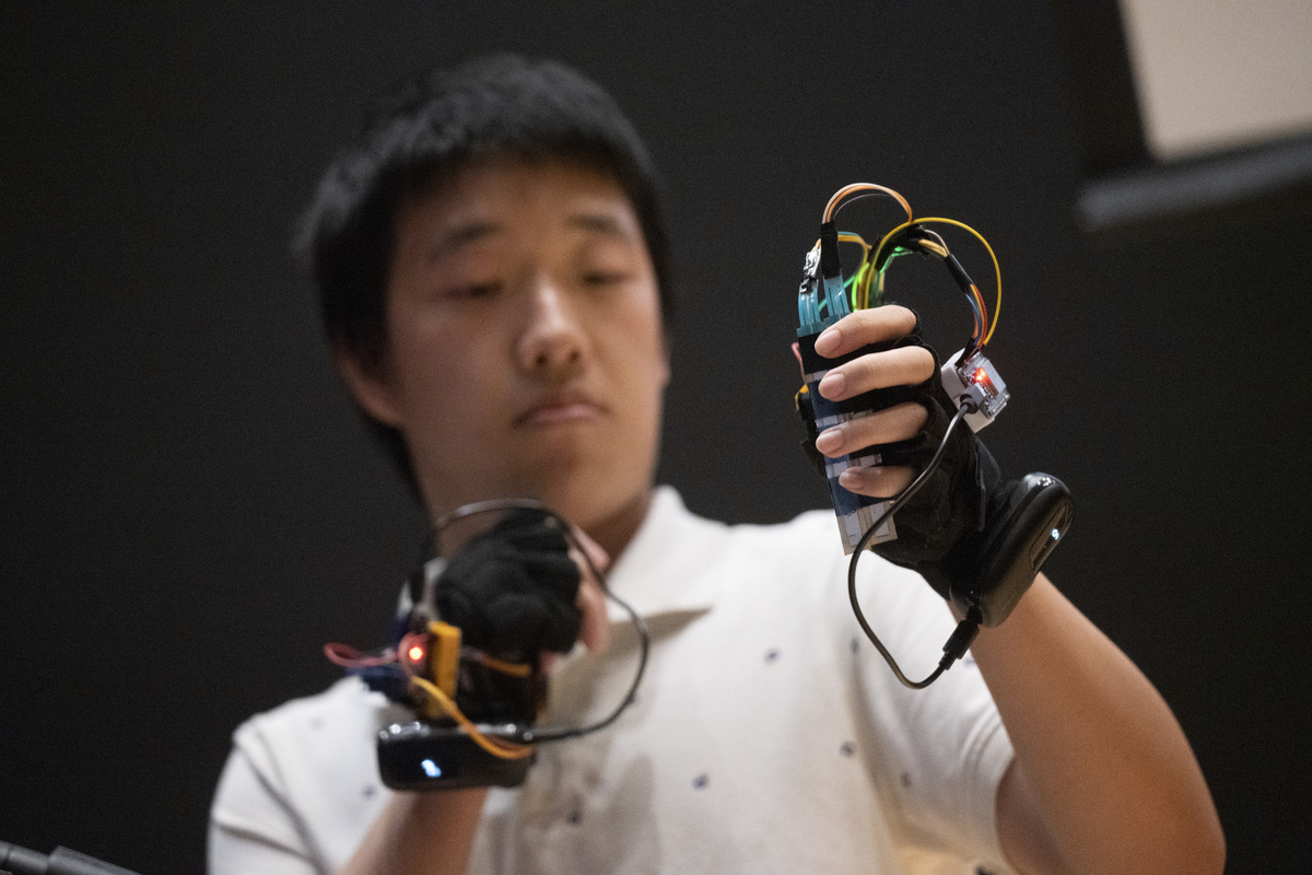 Computer engineering student Zhengyang Zhuang plays the Glove Band at E-SONIC (Steve Zylius/UCI)