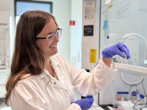 Stacy Copp looks at tubes of nanoclusters at her UCI lab. (Photo: Natalie Tso/UCI)