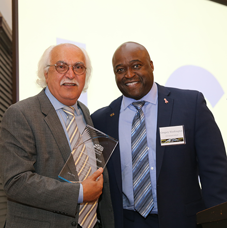 Sorooshian holds an engraved plaque from Dean Gregory Washington during his tribute dinner.