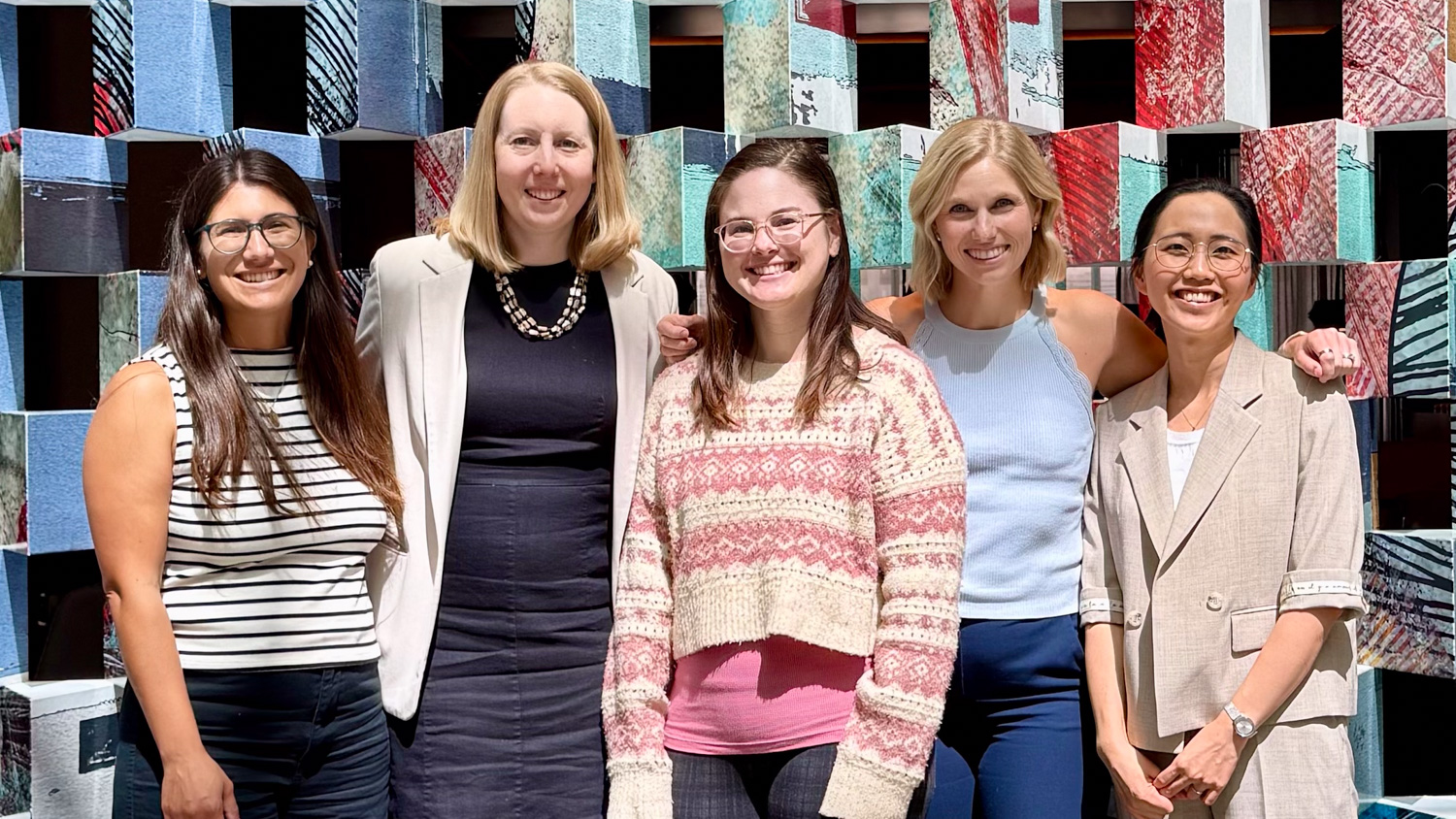Image of five women posing for a photo.