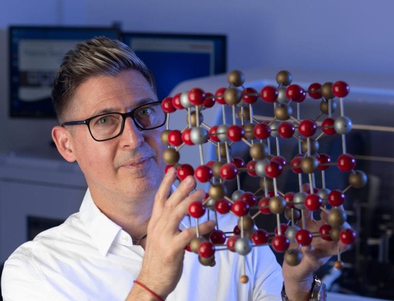 David Kisailus, UCI professor of materials science and engineering, holds a model of crystal magnetite. He and his fellow researchers found that microbes living in Chile’s Atacama Desert transform magnetite to a different iron oxide phase called hematite in the process of acquiring the iron that’s necessary for their survival in a harsh environment. Steve Zylius / UCI