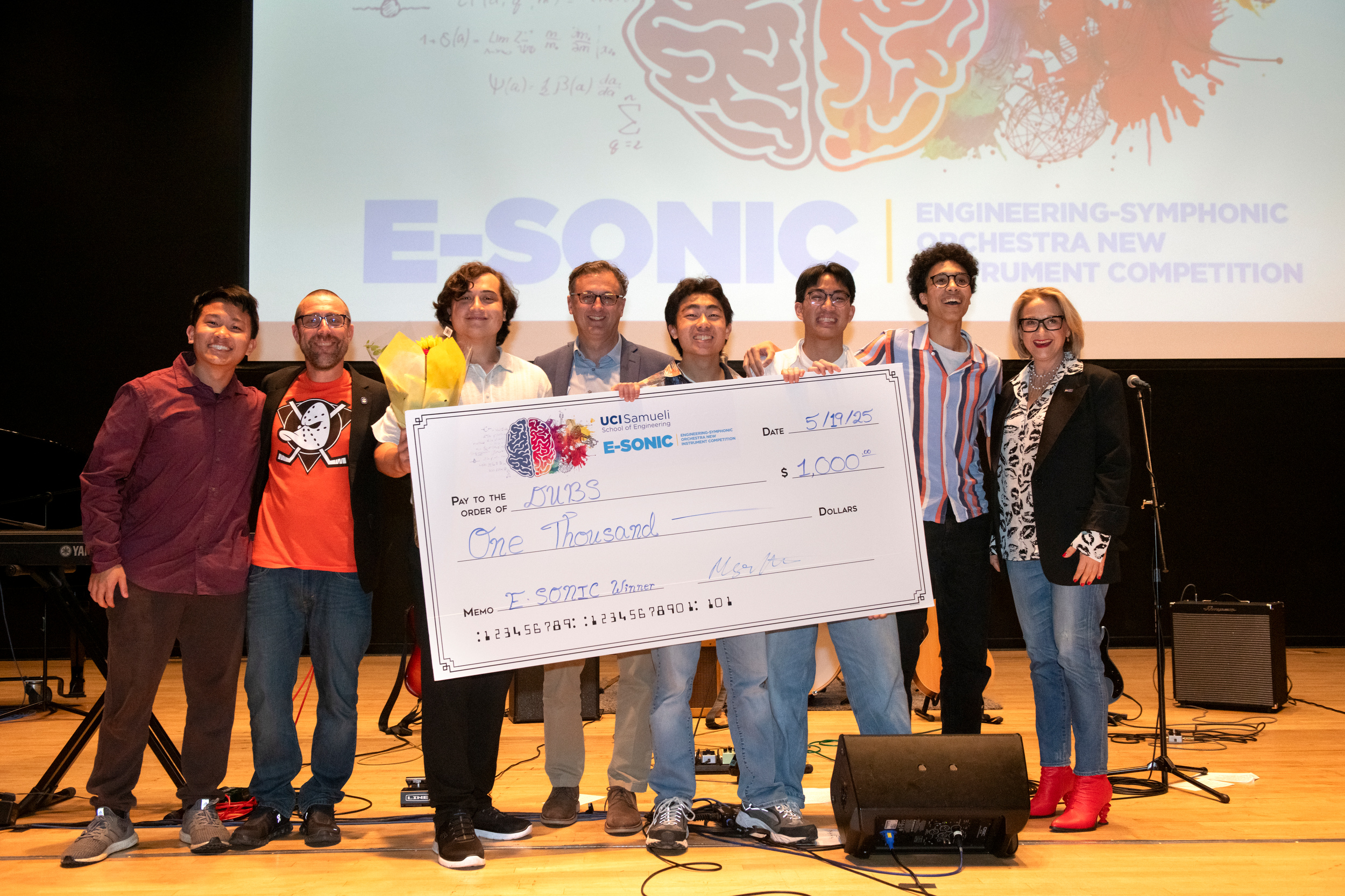 From left: DUBS team UCI chemical engineering student Devin Duong, Samueli School of Engineering Dean Magnus Egerstedt, political science student Zachary Lee, Pacific Symphony President and CEO John Forsyte, mechanical and aerospace engineering student Kevin Meng Xiong, chemical and biomolecular engineering student Dylan Nam Nguyen, electrical engineering student Ibrahim Hussein, and Claire Trevor Dean of the Arts Tiffany López (Steve Zylilus/UCI)