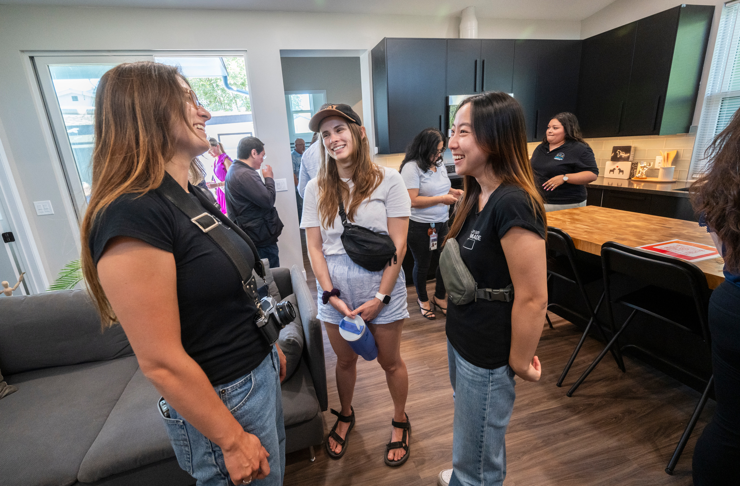 TeamMADE members from left: Georgie Ampudia, Alexandra Huff and Yuka Suzuki in the home’s living room at the opening. (Photo: Steve Zylius/UC Irvine)