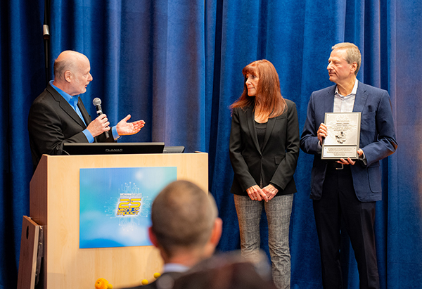 UCI Chancellor Howard Gillman presents a special plaque to Susan and Henry Samueli.