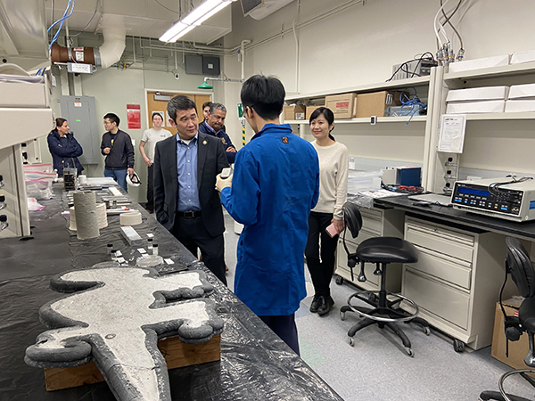 U.S. Rep. Dave Min speaking with graduate student Jianlei Wen about cement research.