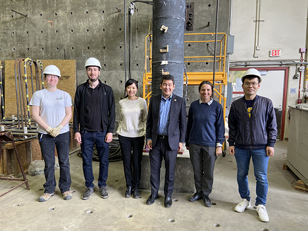 From left, Kathryn Jones, Amadeu Malats Domenech, Mo Li, Dave Min, Iryna Zenyuk and Wei Geng stand in front of a robotically additively manufactured concrete column being tested for structural performance.