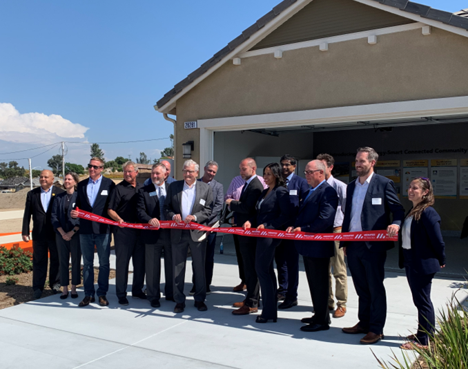 Department of Energy Assistant Secretary Moreno cuts the ribbon at the grand opening of two microgrid residential communities. 