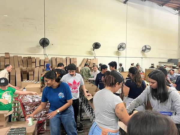 Engineers Without Borders student volunteers prepare donations in collaboration with the Second Harvest Food bank of Orange County.