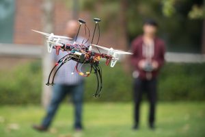 UCI associate professor of computer science Ian Harris (left) and mechanical engineering undergraduate Erin Ho perform a test flight of their rescue robot. Steve Zylius / UCI