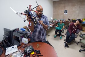 UCI associate professor of computer science Ian Harris (left) works with Bonnie Gonzalez and Erin Ho to prepare their drone for flight in UCI’s Rescue Robotics Invitational. Steve Zylius / UCI