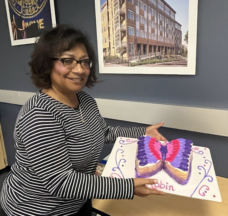 Long-time Undergraduate Student Affairs Director Robin Jeffers shows off the cake at her retirement celebration in June.