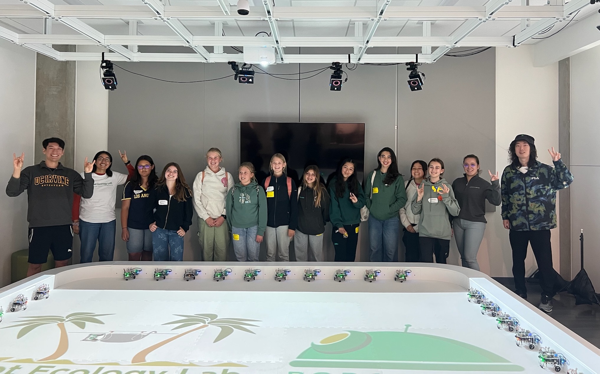 Graduate students Alex Nguyen, Diana Morales, Riwa Karam, Ruoyu Lin with a group of middle school students in the Robot Ecology Lab. 