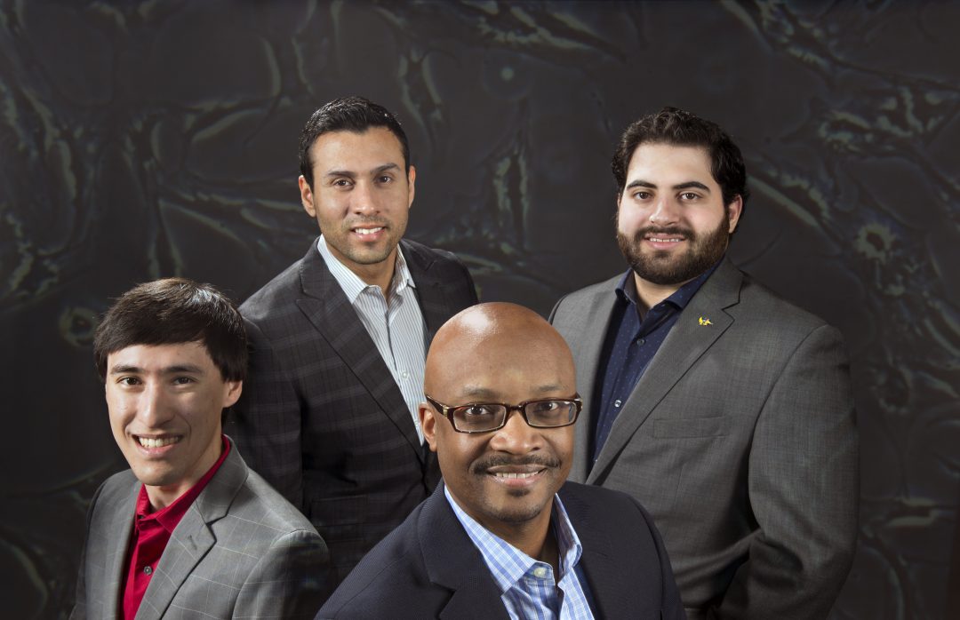 Syntr founders Justin Stovner, Hugo Salas, Dr. Derek Banyard and Ahmed Zobi (from left) assemble before a vastly magnified, high-resolution image of the type of stem cells their startup utilizes. Steve Zylius / UCI