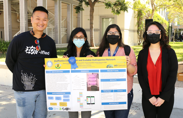 Quoc-Viet Dang, assistant professor of teaching, stands proudly with the ZotPonics 3.0: A Smart and Scalable Hydroponics Network team at the 2022 Winter Design Review, where the team earned a Dean’s Choice Award. Pictured with Dang, from left, are Rashmi Sharma, Megha Kak and Melinda Tran.