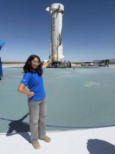 Uma Iyer in front of Blue Origin’s New Shepard rocket at Launch Site One in Van Horn, Texas