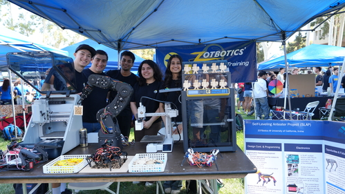 5 students stand at a booth for ZotBotics at UCI's Anteater Involvement Fair for clubs.